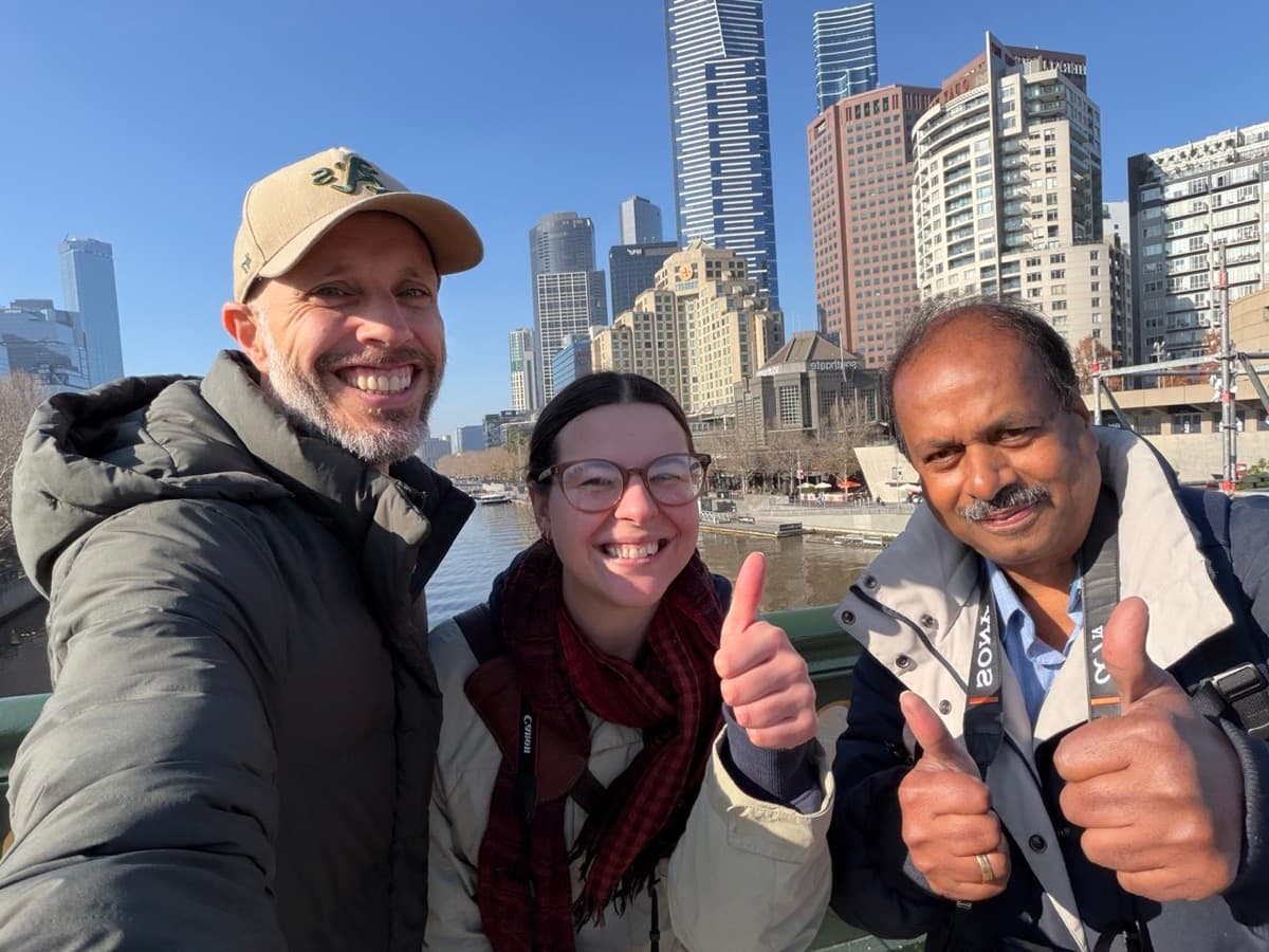 Elan and Cosette with Daniel Bilsborough over the Yarra River with the Melbourne CBD skyline behind during a photography course