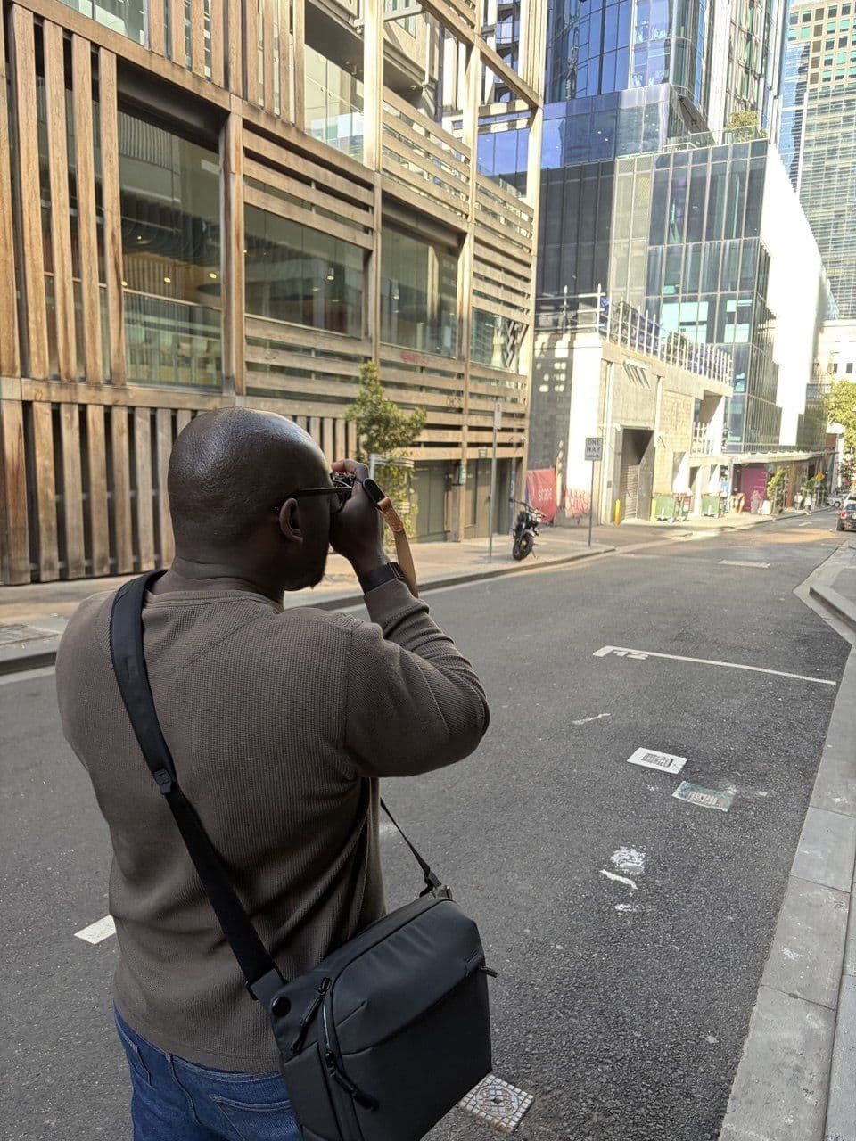 A student shooting down a Melbourne CBD street during a photography course