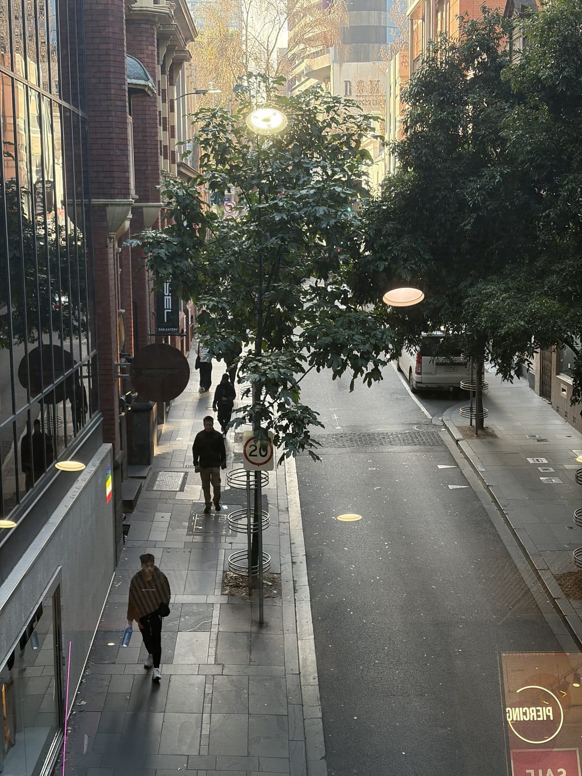 A Melbourne CBD laneway with morning sun coming down the far end, people walking past shopfronts, on the Sony A7 III photography course