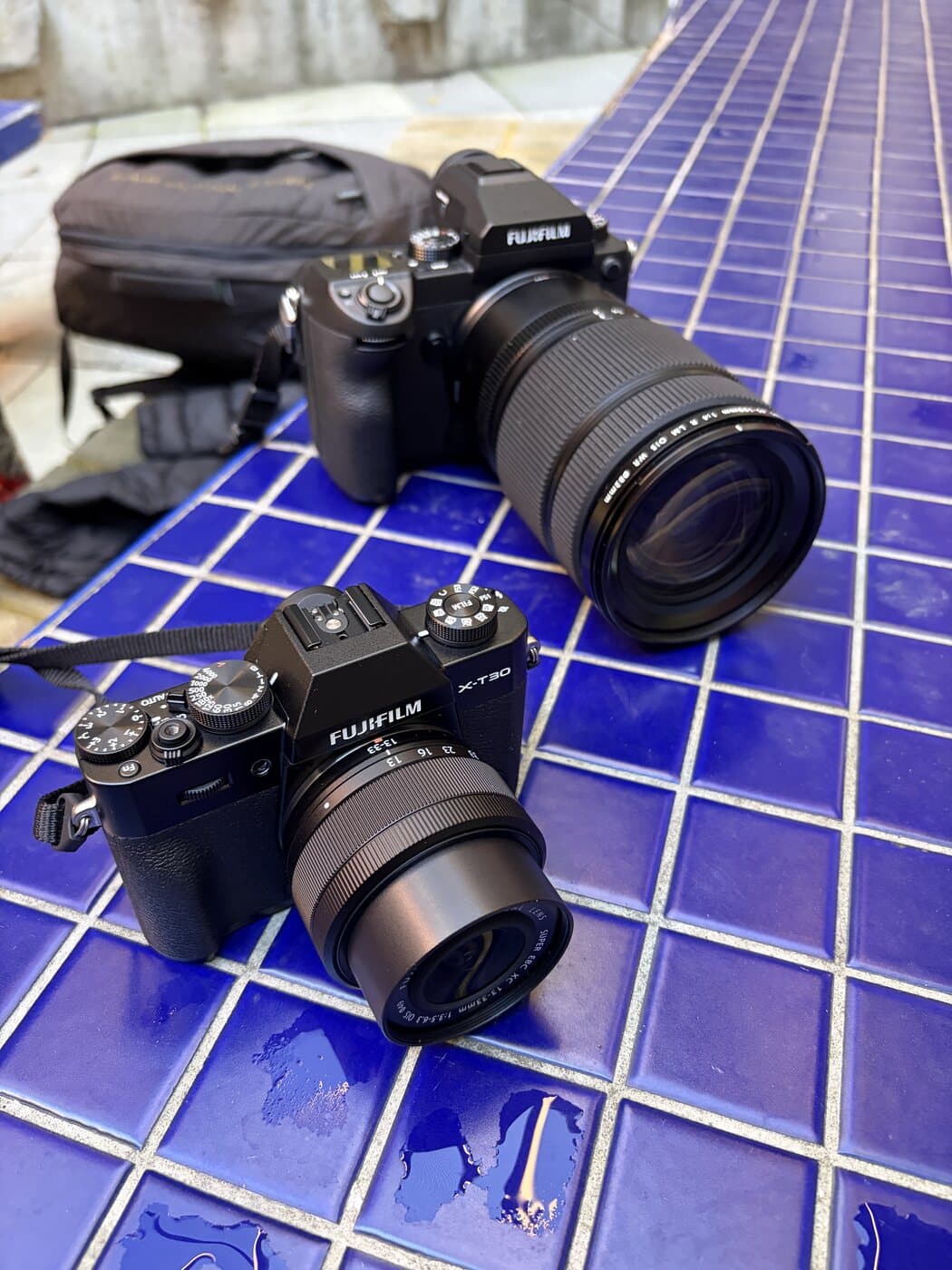 A Fujifilm X-T30 III with the XC 15-45mm kit lens beside a medium-format Fujifilm GFX 50S with a 45-100mm lens during a Melbourne photography course